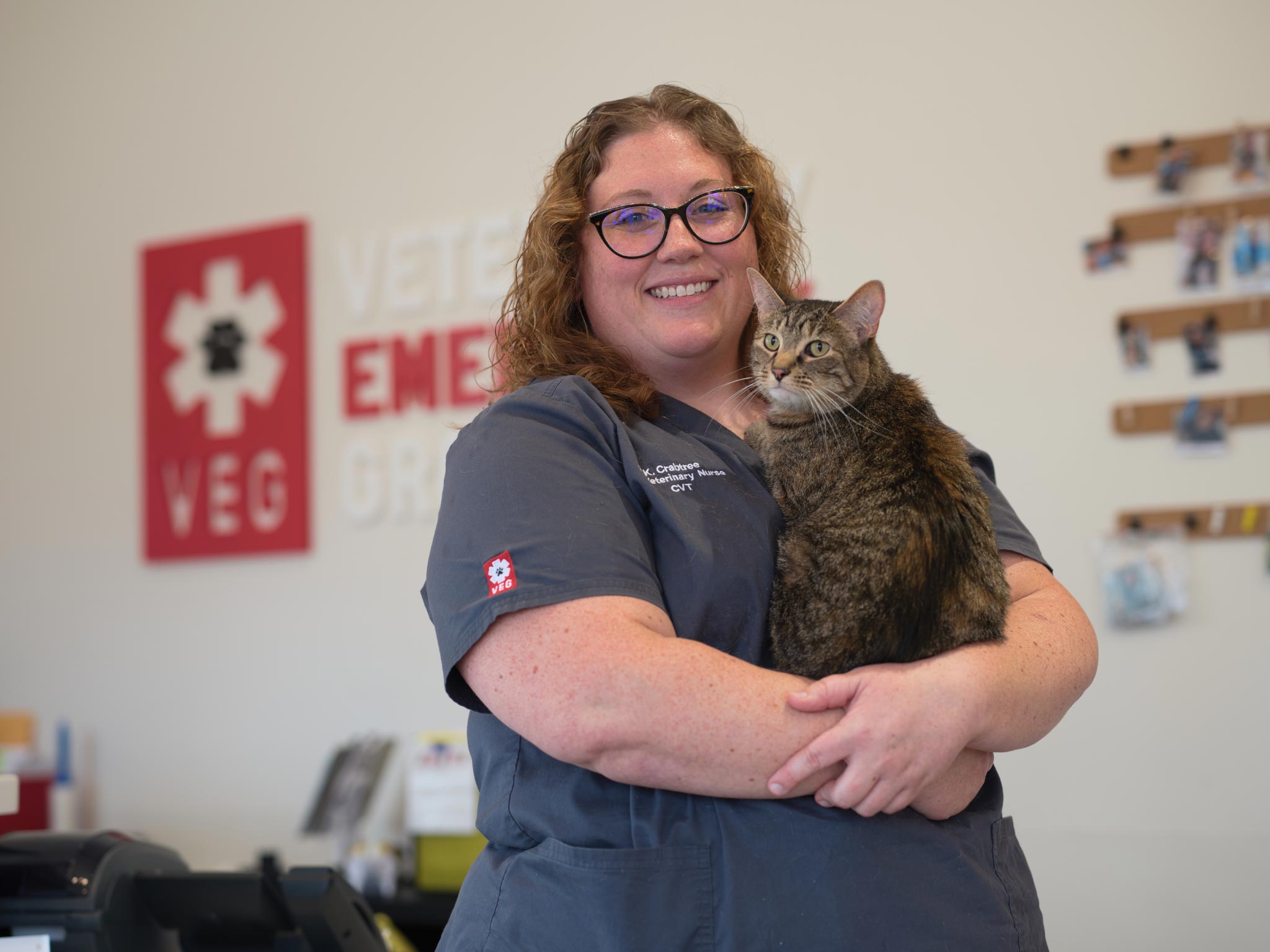 staff member holding cat and smiling